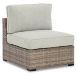 Armless wicker patio chair with light gray cushions.